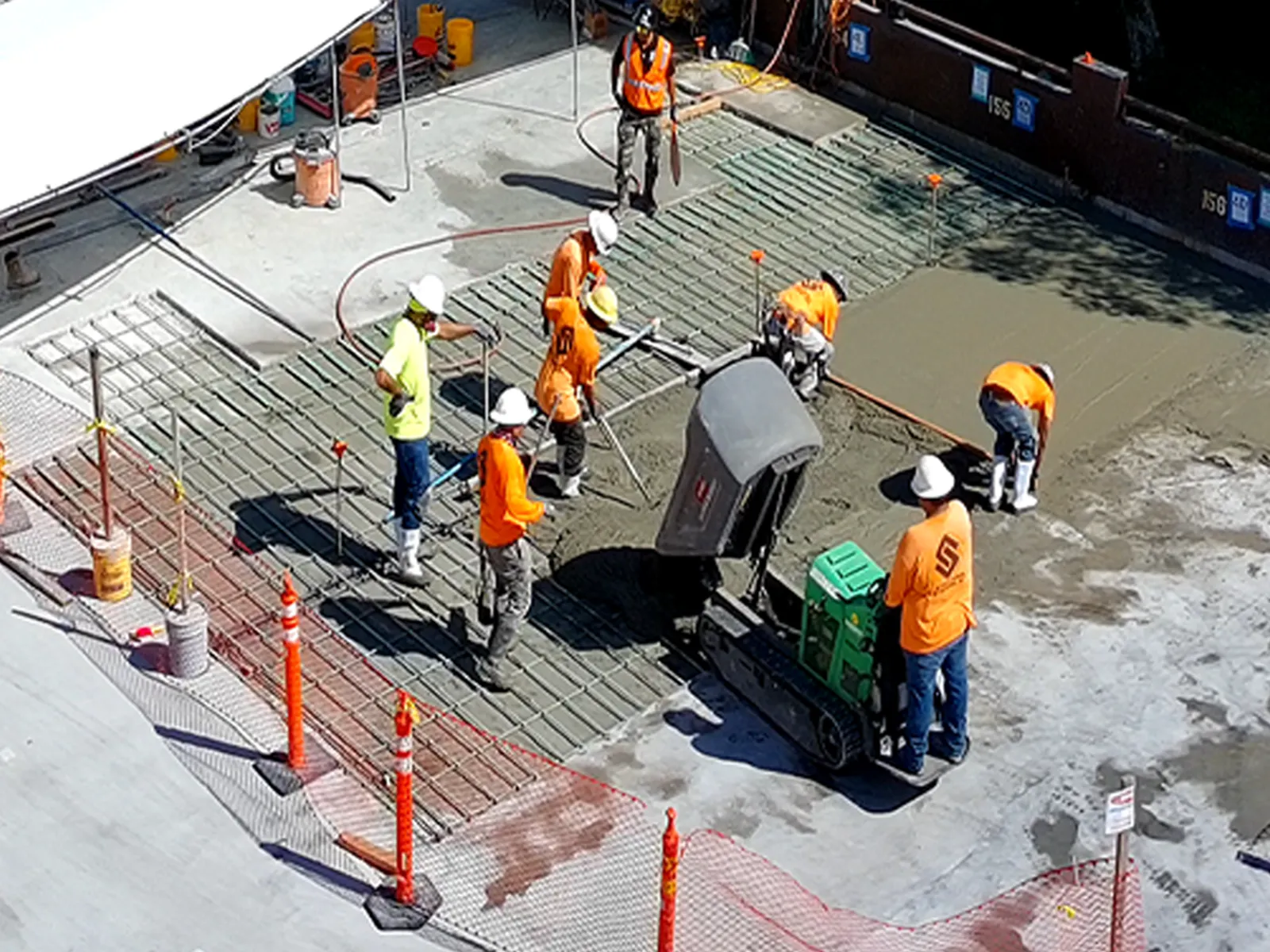 Structural Systems Hawaii crew pouring and finishing concrete slab for spall repair on rooftop deck