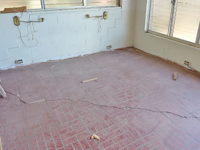 Structural Systems Hawaii concrete slab crack from foundation settlement before releveling repair.